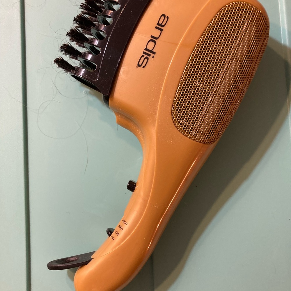 Hair dryer, handheld with brush attachment.